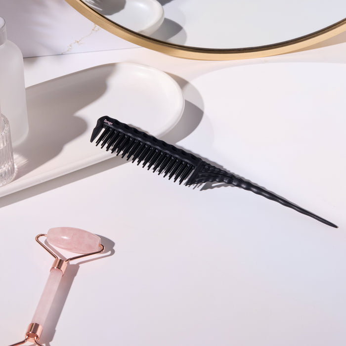 Black pin-tail teasing comb on a vanity tray
