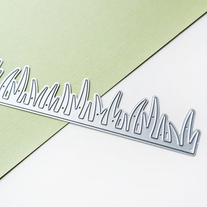 Catherine Pooler - Die - Grass Border. No need to break out the lawn mower, this die is just right year round! The Grass Border die gives just that touch of extra and finish to your card scenes. Use the Gardener's Greetings Stamps and the Backyard Border Stamps to create a bloomin' card for any reason. Available at Embellish Away located in Bowmanville Ontario Canada.