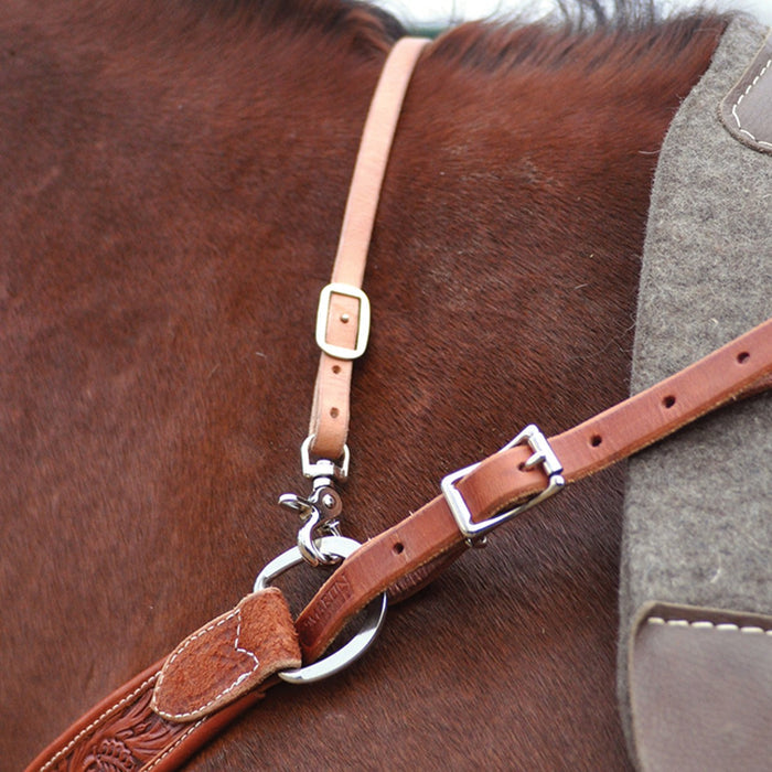 Close-up of wither strap attached over horse's withers annd attached to D ring on end of breast collar.