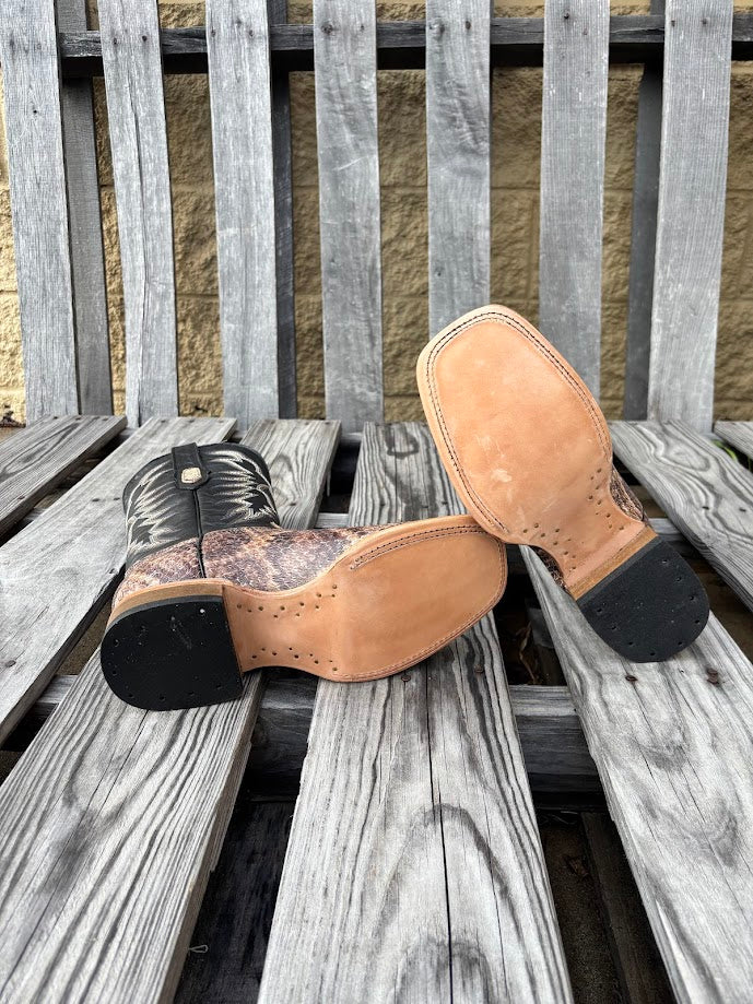 Men's square-toe boots with natural rattlesnake print leather on the vamp and a 12 inch Black leather shaft with a detailed stitch pattern. Bottom view showing leather outsole.