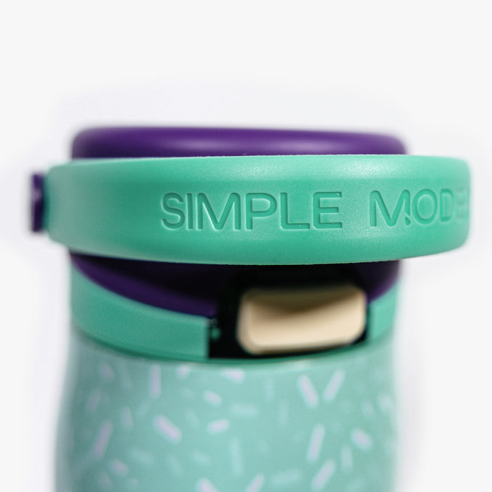 Adult model wearing multi-color water bottle with "Mesa Sport" design