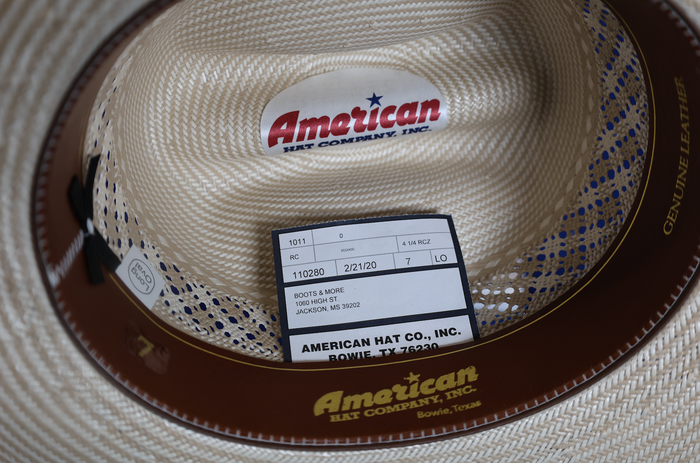 Inside view American Hat company straw hat featuring a leather sweat band.
