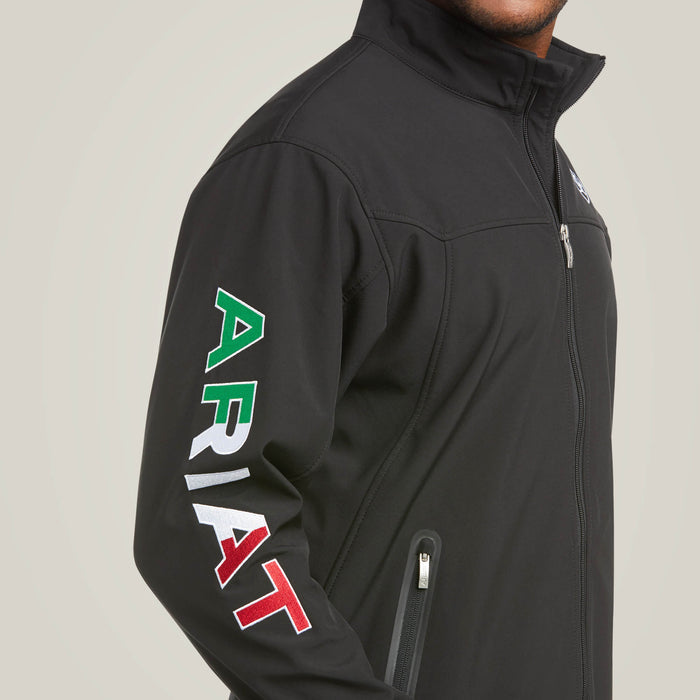 Men's Ariat softshell Team logo jacket in black with a blocked Ariat logo in white, green, and red representing the Mexican Flag. Close up showing blocked Ariat logo on right arm in Red, White, and Green. This view also shows a close up of the zippered hand pocket.