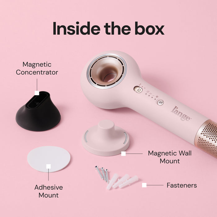 "Inside the box" graphic showing L'ange pink hair dryer accessories labeled Magnetic Concentrator, Magnetic Wall Mount, Adhesive Mount, and Fasteners, with pink dryer in background.