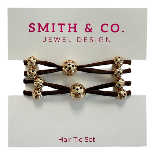 Hair tie set with gold beads on a Smith & Co. card