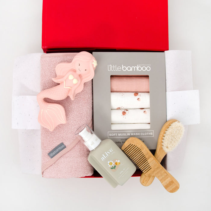 Baby care product set with towel, washers, baby oil, brush, and comb and mermaid teething toy. $139.00