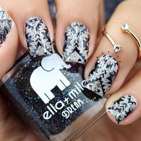 Black Magic glitter nail polish with black and white patterned nail art