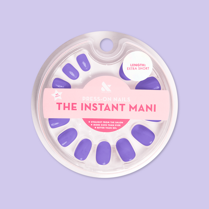 Round extra short purple press-on nails in clear blister pack labeled Bold & Unshaken - Press-On | Extra Short | Round