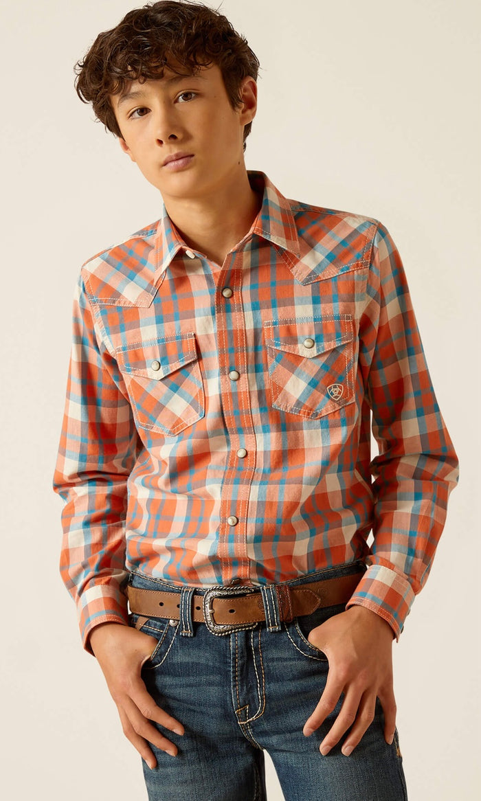 Boy's Ariat long sleeve Retro fit snap shirt in Arabesque, a orange and blue plaid.  Front view showing shirt tucked in.