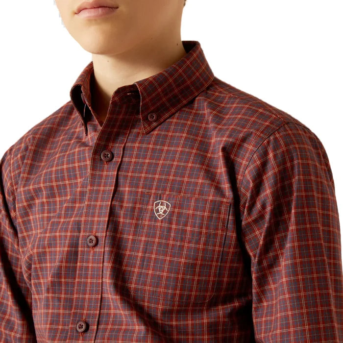 Boy's Ariat Pro series long sleeve shirt in Burgundy Plaid. Close up of button down collar and Ariat shield logo on left chest pocket.