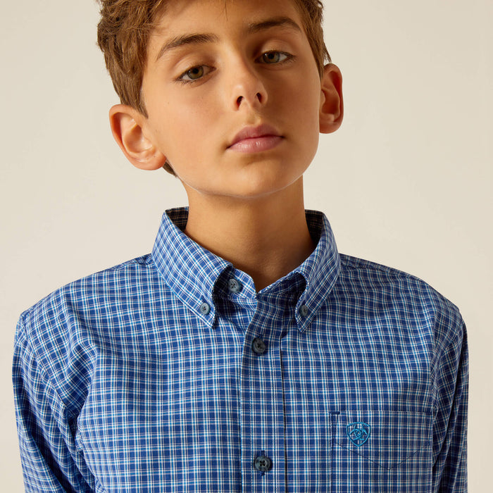 Boy's Ariat long sleeve Pro Series shirt in Blue Plaid. Close up of button down collar and Ariat shield logo stitched on left chest.
