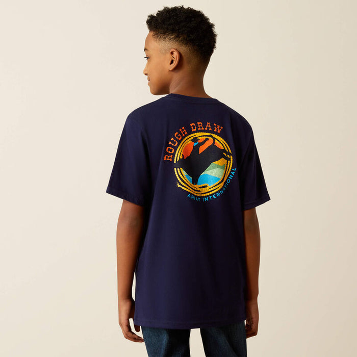 Boy's Ariat short sleeve tee in Classic Blue. Rear view showing shirt untucked faturing a Rough Draw bull rider graphic and Ariat International logo.