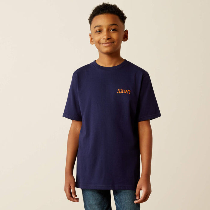 Boy's Ariat short sleeve tee in Classic Blue. Front view showing shirt untucked and Ariat graphic logo on left chest.