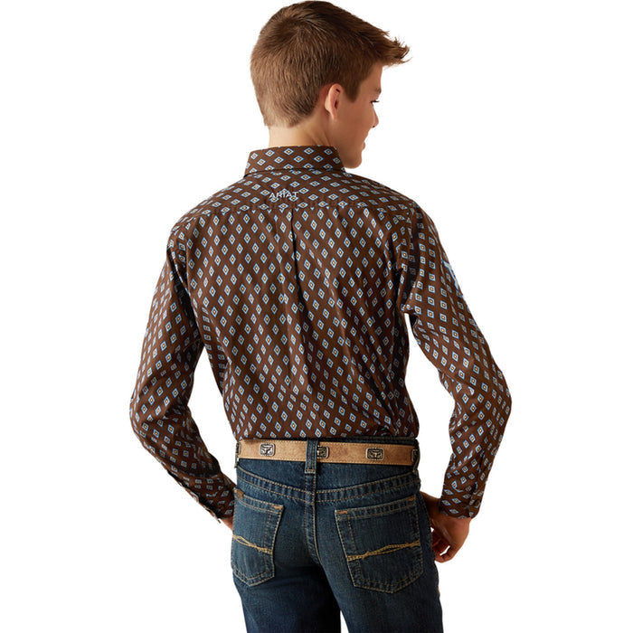 Boy's Ariat long sleeve team logo shirt in brown with a blue diamond pattern. Rear view showing shirt tucked in and Ariat logo on straight yoke.