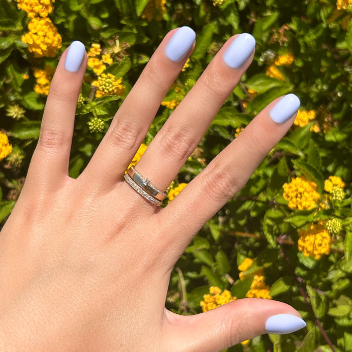 BP - Press-On | Extra Short | Round showing hand with icy light blue extra short round press-on nails outdoors by yellow flowers