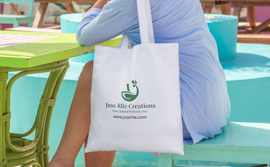 Person sitting at a table with a white tote bag featuring 'Juss Rite Creations' branding.