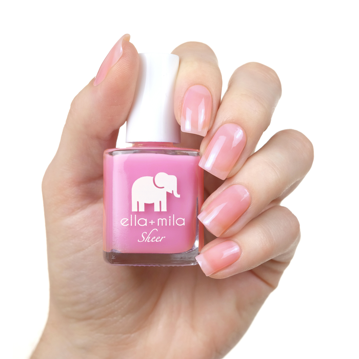 Brave sheer pink nail polish manicure on a light skin tone with the bottle