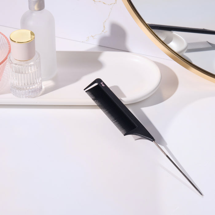 Black metal pin-tail teasing comb on a vanity tray