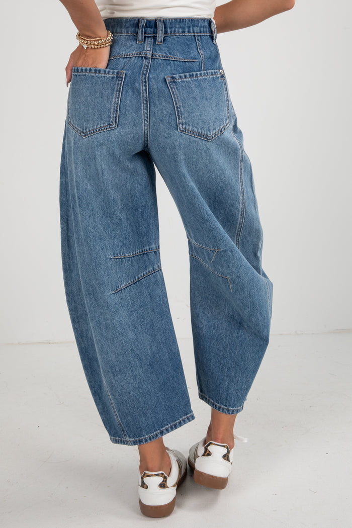 Person wearing blue jeans on a white background
