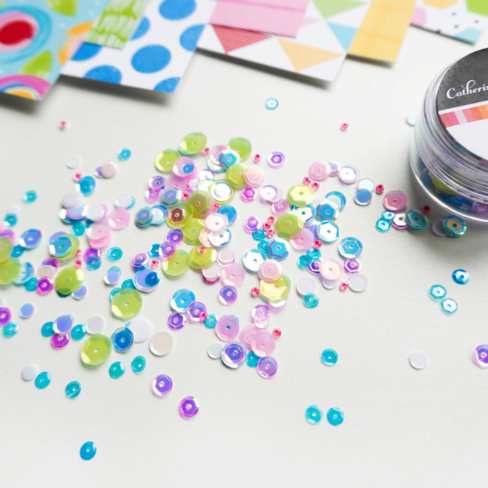 Catherine Pooler - Sequin Mix - Scranton. If you are looking for Dwight's missing highlighters, we put them in the Scranton Sequin Mix!! Named for Scranton, PA with a nod to the location of the fictitious Dunder Mifflin Paper Company, this bright and vibrant mix of highlighter pink, green and blue sequins. This mix brings the sparkle and pairs perfectly with our Sketchbook Patterned Paper. Available at Embellish Away located in Bowmanville Ontario Canada.