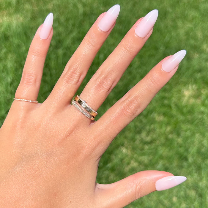 CCT - Press-On | Long | Almond showing hand with sheer pink long almond press-on manicure outdoors on grassy background