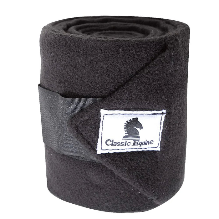 Classic Equine Classic Polo Wrap shown rolled up and closed by its velcro strap and displaying the Classic Equine cloth logo label. Shown in black.
