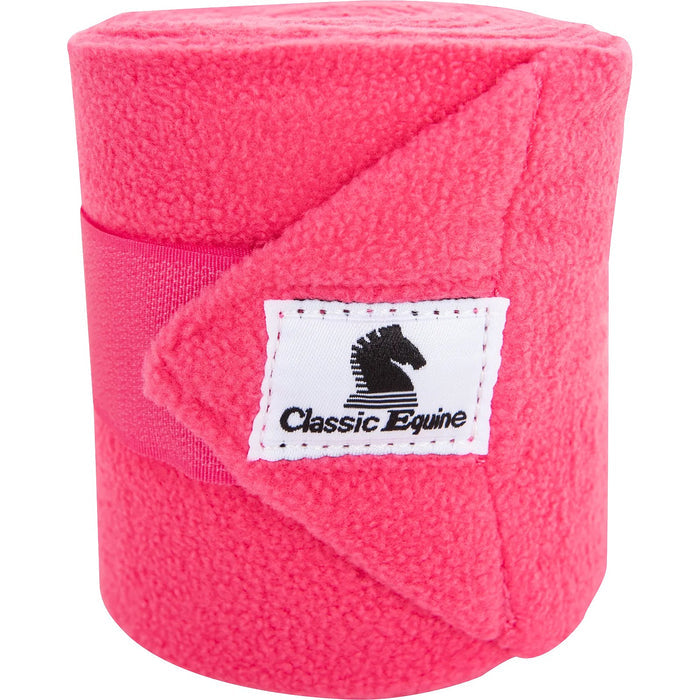Classic Equine Classic Polo Wrap shown rolled up and closed by its velcro strap and displaying the Classic Equine cloth logo label. Shown in hot pink.