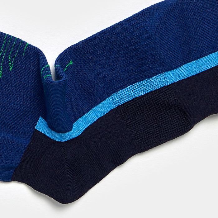 A close-up of a blue and navy striped fabric with a textured, wavy fold and a thin light blue line dividing the two main colors.