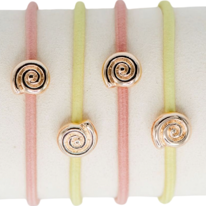 Set of four hair ties with spiral designs on a white background