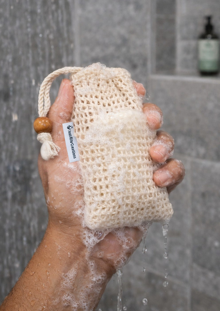 A person holding a Juss Rite Creations sisal soap bag with natural bar of soap inside