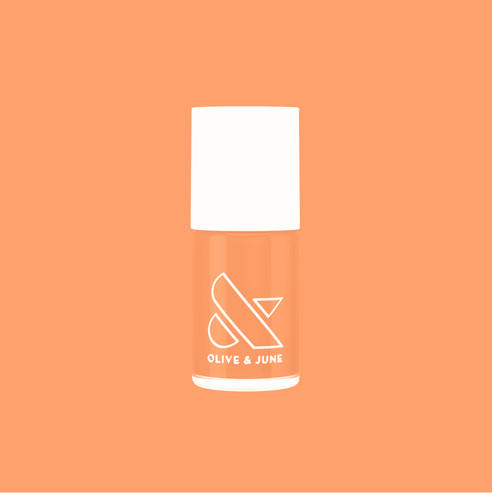 Olive and June Counselor In Training gel polish bottle in bright cantaloupe orange on matching background