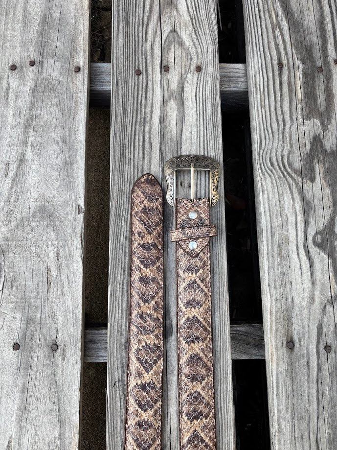 Natural rattlesnake print leather belt showing removable buckle and belt tip.