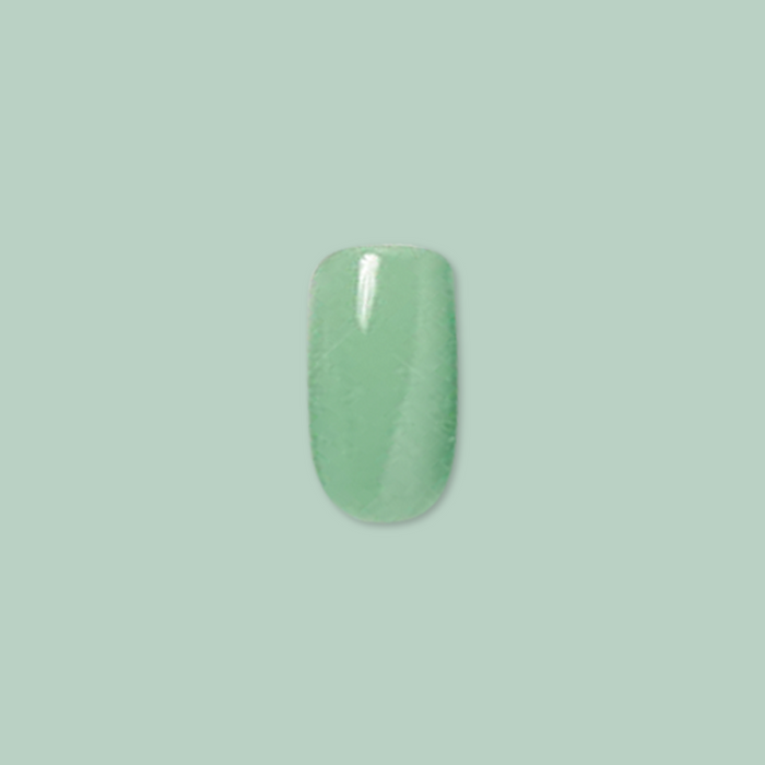 Cucumber Sandwich - Press-On | Short | Round showing single short round fresh green false nail on pale green background