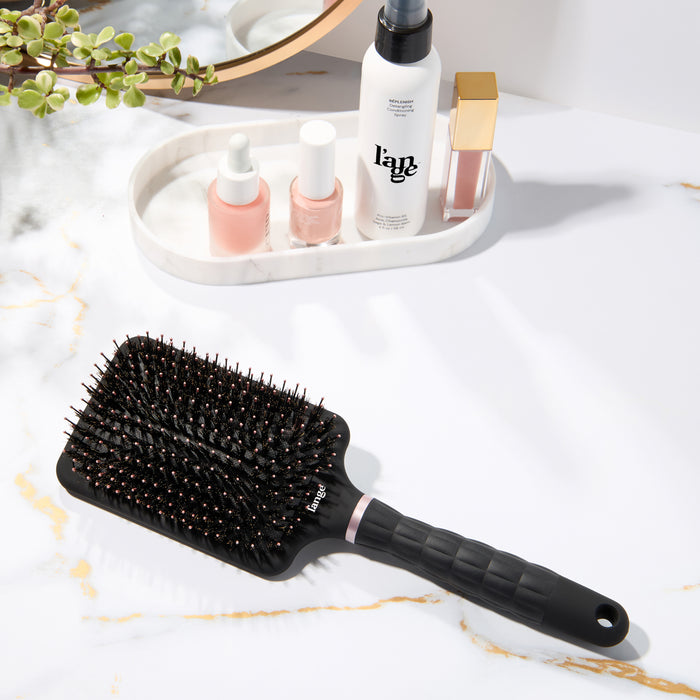 L’ange detangling paddle brush with boar  on a vanity