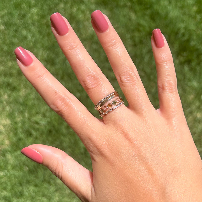 Fig Ranch - Press-On | Short | Squoval showing hand with short squoval cool-toned fig pink press-on manicure outdoors on grass background