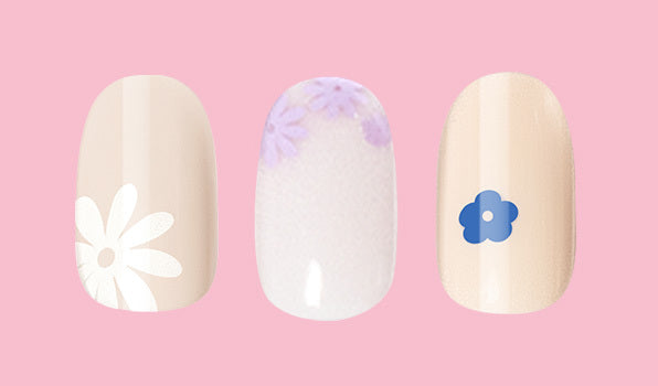 Floral Trio showing three press-on nails with beige base and delicate white and purple floral designs for easy mani