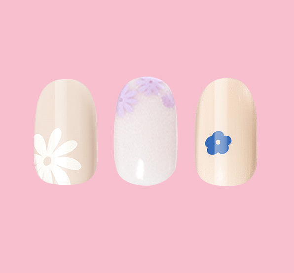 Floral Trio showing three beige and white press-on nails with delicate blue and purple floral designs for easy mani application