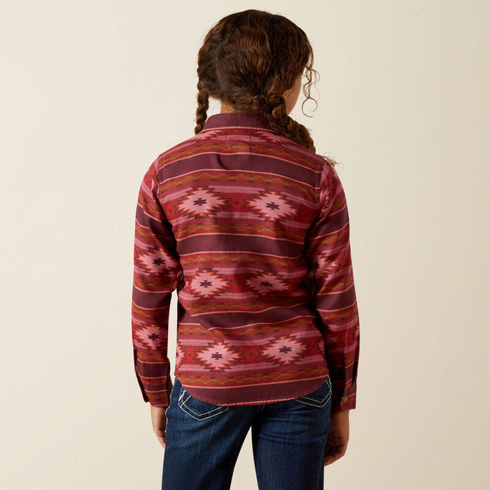 Girl's Ariat long sleeve shirt in Rosa Southwestern, shirt has pearl snaps and a Southwestern style pattern in burgundy and red tones. Rear view showing shirt untucked.