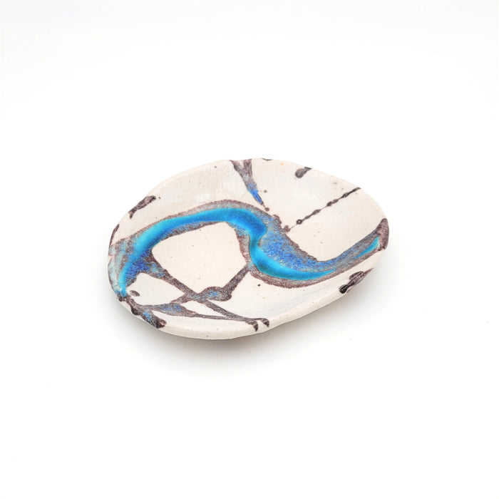 A small, oval-shaped ceramic plate with a unique multicolor glaze design resembling a frozen river or hyoga pattern, with shades of blue and white.