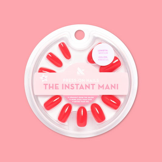 Hibiscus - Press-On | Medium | Oval showing medium oval false nails in bright tropical pink in circular packaging on pink background