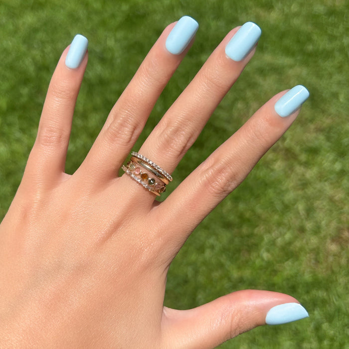 Honest & True - Press-On | Short | Squoval showing hand with serene blue short squoval press-on nails outdoors on green grass background