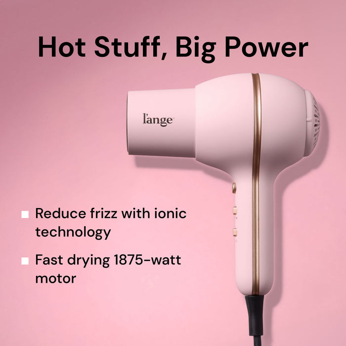 L'ange Hot Stuff blush hair dryer on pink background. "Hot Stuff, Big Power – Reduce frizz with ionic technology. Fast drying 1875-watt motor"