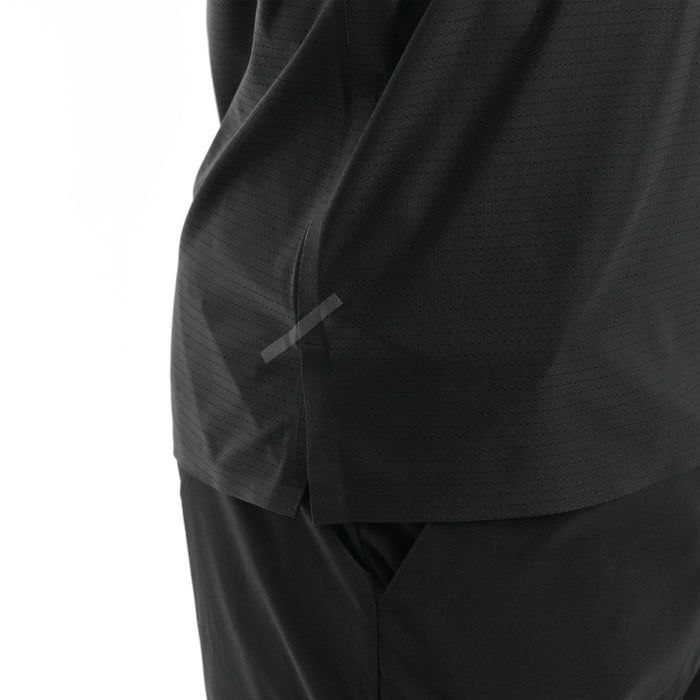 Close-up of a black garment with a tape on a white background.