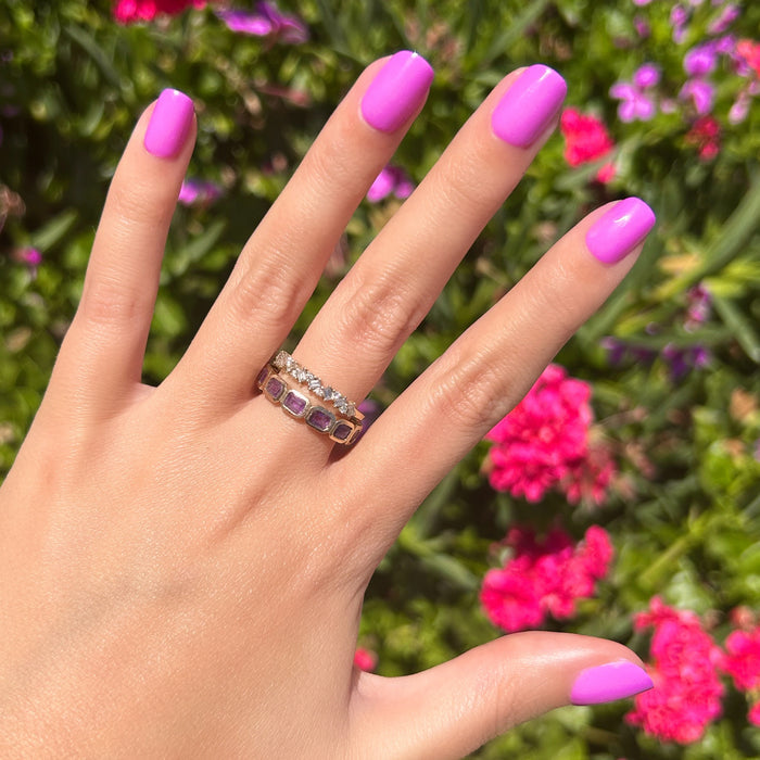Jam, Please - Press-On | Extra Short | Squoval showing hand with bright soft magenta false nails outdoors with pink flowers background
