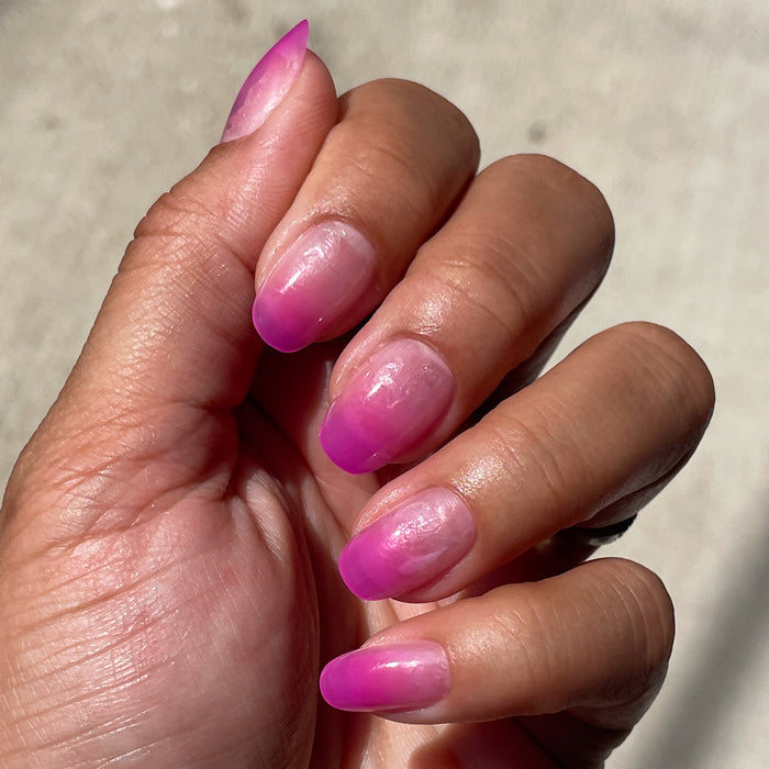 Jelly Magenta Gradient - Press-On | Short | Round showing a bright jelly magenta gradient mani on natural nails outdoors