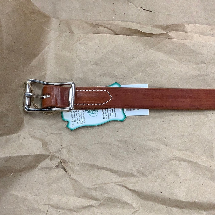 Buckle of chestnut harness leather breast collar tug.