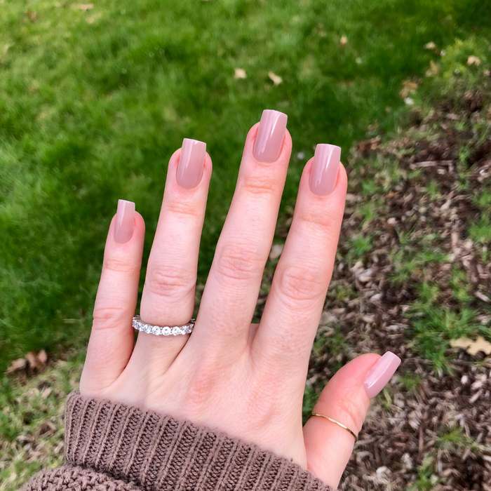 Mauve Gloss - Press-On | Medium | Square showing a hand with glossy mauve medium square press-on manicure outdoors