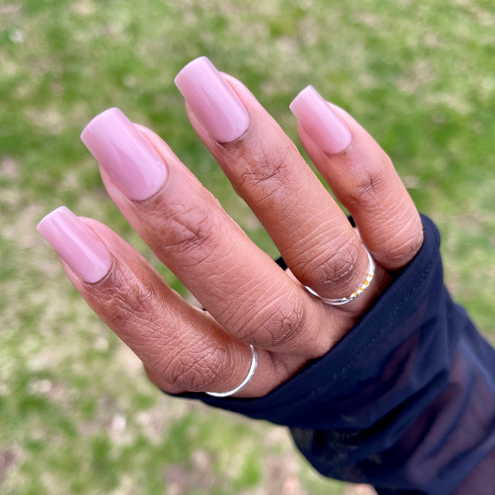 Mauve Gloss - Press-On | Medium | Square showing hand with glossy mauve medium square press-on manicure outdoors on green background