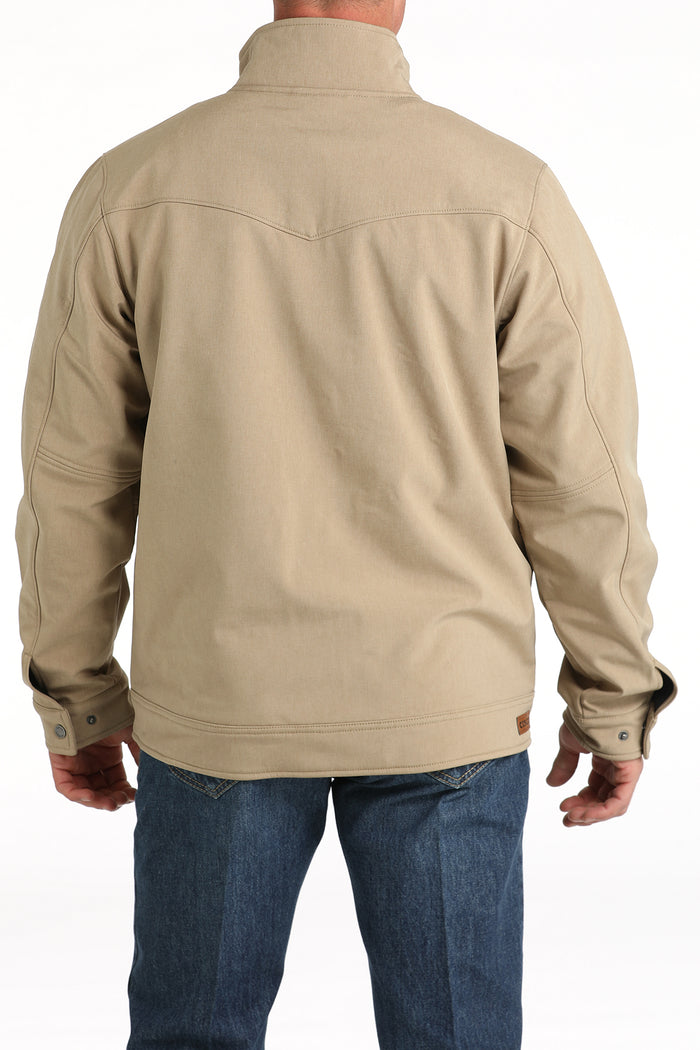 Cinch khaki conceal carry jacket. Has adjustable standing collar, snap cuffs, leather Cinch patch on right side of waist . Fits below waist. Back view.