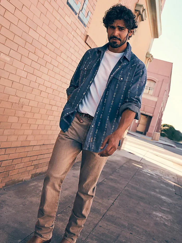 Lifestyle photo of men's Wrangler saddle tan Retro fit jeans.